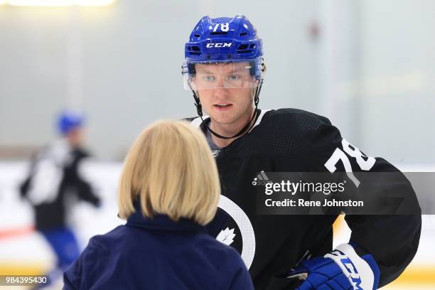 Rasmus Sandin talks to skating consultant for the Toronto Maple Leafs Barb Underhill while on the ice at the Leafs training facility in Etobicoke....