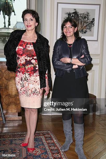 Singer Luz Casal poses with Anne Hidalgo before being decorated with the 'Honor medal of the city of Paris' by Bertrand Delanoe at Hotel de Ville on...