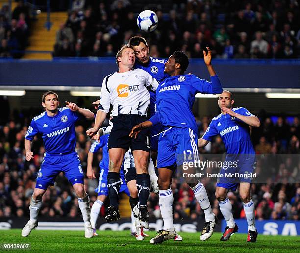 Kevin Davies of Bolton Wanderers jumps for the ball with John Terry of Chelsea during the Barclays Premier League match between Chelsea and Bolton...