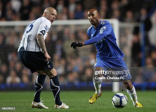 Nicolas Anelka of Chelsea runs with the ball past Gretar Steinsson of Bolton Wanderers during the Barclays Premier League match between Chelsea and...