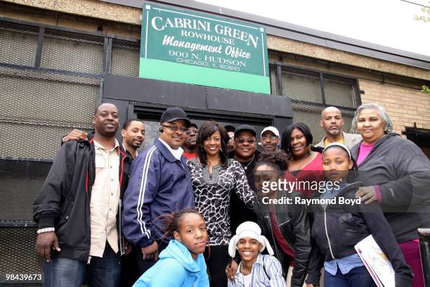 Actress BernNadette Stanis, poses for photos with residents of Cabrini Green during a Public Housing Tour in Chicago, Illinois on APRIL 12, 2010.