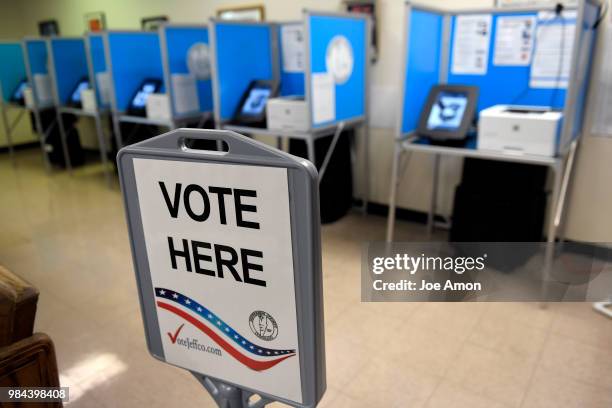 Dropping off ballots and voting at the Jefferson County DMV June 26, 2018 in Arvada, Colorado.