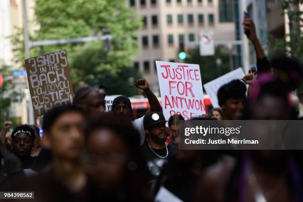 Demonstrator holds up a sign that reads "Justice for Antwon Rose" during a protest a day after the funeral for Rose on June 26, 2018 in downtown...