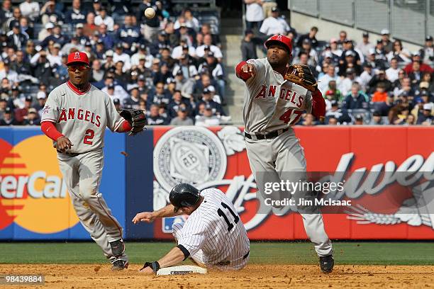 Howard Kendrick of the Los Angeles Angels of Anaheim turns a double play over Brett Gardner of the New York Yankees during the Yankees home opener at...