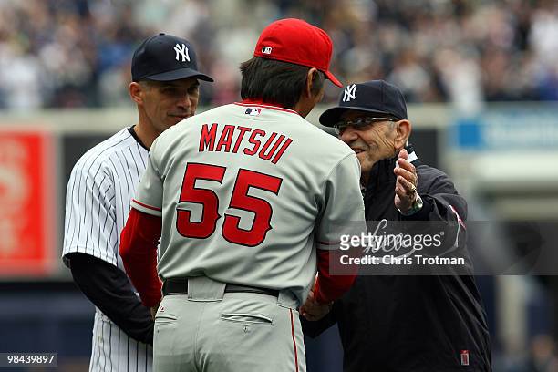 Hideki Matsui of the Los Angeles Angels of Anaheim is greeted by hall of famer Yogi Berra after he received his World Series ring for being a member...