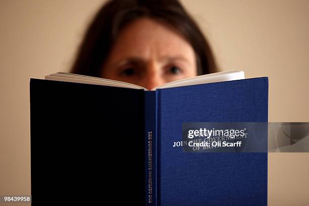 In this photo illustration, a woman reads a copy of the Conservative party manifesto which was launched today on April 13, 2010 in London, England....