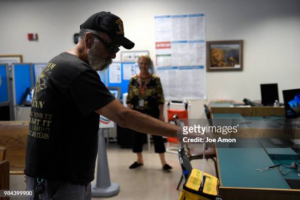 Tony Solano of Arvada dropping off his mail in ballot at the Jefferson County DMV June 26, 2018 in Arvada, Colorado.