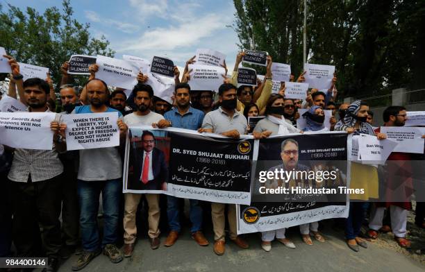 Journalists hold placards during a protest against the assassination of veteran journalist and Editor-in-Chief of Daily Rising Kashmir Syed Shujaat...