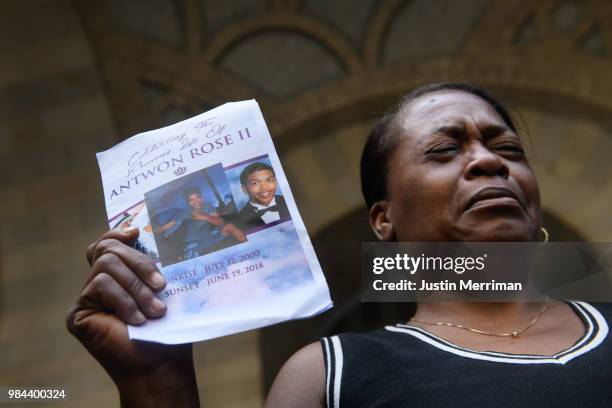 Carmen Ashley, the great aunt of Antwon Rose II, cries as she holds the memorial card from Rose's funeral during a protest calling for justice for...