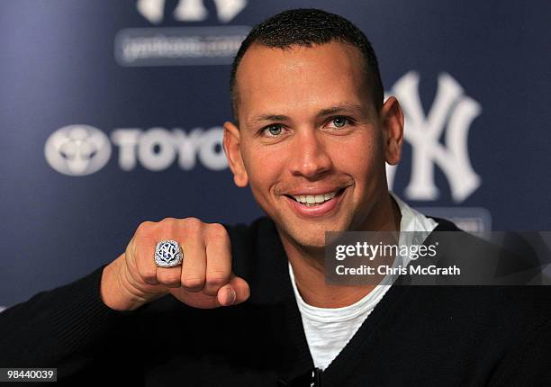 Alex Rodriguez of the New York Yankees shows off his World Series ring to the media during a press conference after the Yankees home opener at Yankee...