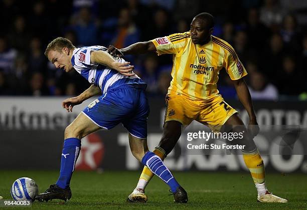 Newcastle United player Shola Ameobi looses possesion to Bryn Gunnarsson of Reading during the Coca-Cola Championship game between Reading and...