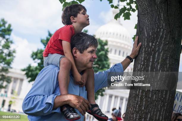 Dr. William Kennedy Smith and his son Stephen attend a rally on the East Front lawn of the Capitol to condemn the separation and detention of...