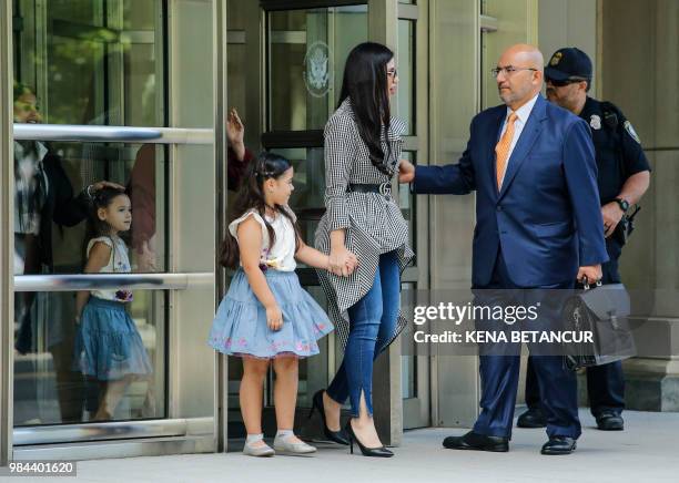 The wife of 'El Chapo', Emma Coronel Aispuro, leaves with her twin daughters from the US Federal Courthouse in Brooklyn after a hearing in the case...