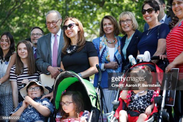 Senate Minority Leader Chuck Schumer , House Minority Leader Nancy Pelosi and Sen. Maggie Hassan pose for a photo with activists outside the U.S....