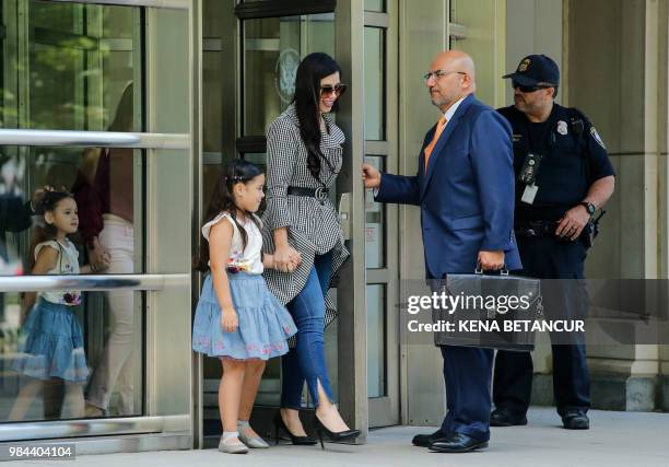 The wife of 'El Chapo', Emma Coronel Aispuro, leaves with her twin daughters from the US Federal Courthouse in Brooklyn after a hearing in the case...