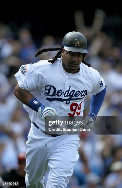 Manny Ramirez of the the Los Angeles Dodgers rounds first base after hitting a home run in the fourth inning against the Arizona Diamondbacks on...