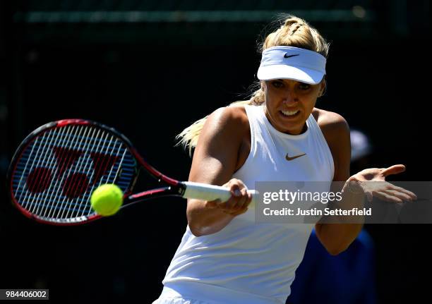 Sabine Lisicki of Germany plays a backhand against Anna Kalinskaya of Russia during Wimbledon Championships Qualifying - Day 2 at The Bank of England...