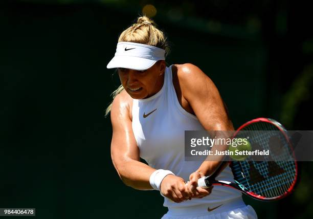 Sabine Lisicki of Germany plays a backhand against Anna Kalinskaya of Russia during Wimbledon Championships Qualifying - Day 2 at The Bank of England...