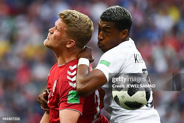 Denmark's forward Andreas Cornelius vies with France's defender Presnel Kimpembe during the Russia 2018 World Cup Group C football match between...