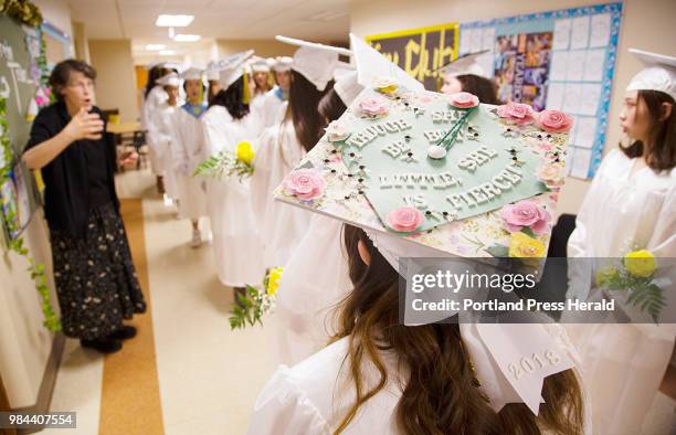 Maine Girls Academy graduate dons a highly decorative mortar board while staging before the graduation ceremony at the Stevens Avenue, Portland...