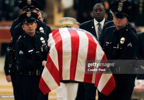 An LAPD honor guard carries Robert James Cottle's coffin down the aisle at the Cathedral of Our Lady of The Angels on April 13, 2010 in Los Angeles,...
