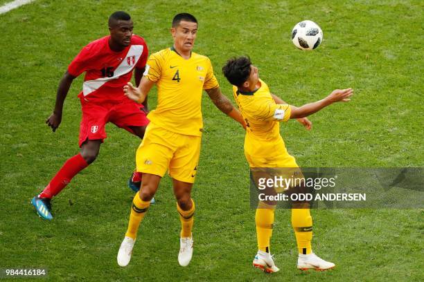Australia's forward Tim Cahill and Australia's forward Daniel Arzani vie for the ball with Peru's defender Christian Ramos during the Russia 2018...
