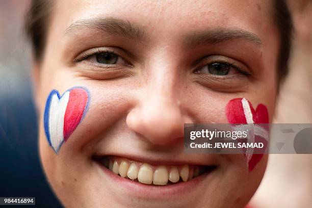 Fan with the French and Danish flags painted on the cheeks smile during the Russia 2018 World Cup Group C football match between Denmark and France...