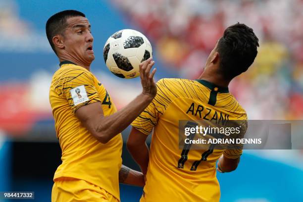Australia's forward Tim Cahill and Australia's forward Daniel Arzani go for the ball during the Russia 2018 World Cup Group C football match between...