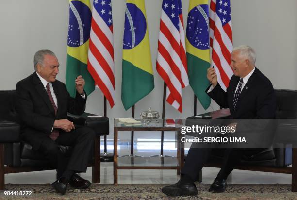 Brazilian President Michel Temer and US Vice-President Mike Pence laugh during a meeting at Planalto Palace in Brasilia on June 26, 2018. - Mike...