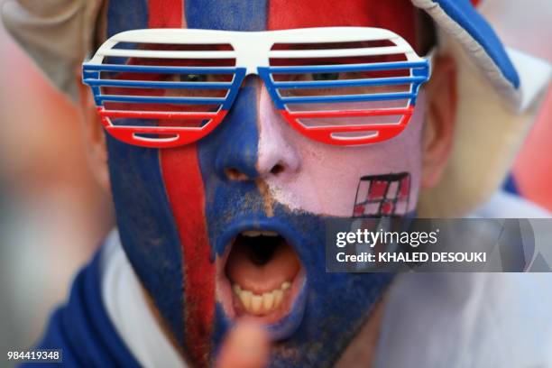 Fan with half his face painted with the Icelandic flag and the other half with the Croatian one poses before the Russia 2018 World Cup Group D...