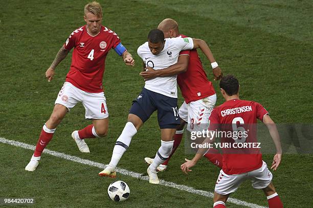 France's forward Kylian Mbappe controls the ball as he is marked by Denmark's defender Mathias Jorgensen during the Russia 2018 World Cup Group C...