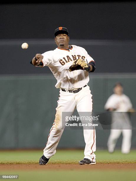 Juan Uribe of the San Francisco Giants throws the ball to first base during their game against the Pittsburgh Pirates at AT&T Park on April 12, 2010...