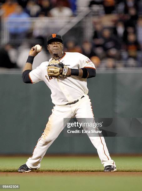 Juan Uribe of the San Francisco Giants throws the ball to first base during their game against the Pittsburgh Pirates at AT&T Park on April 12, 2010...