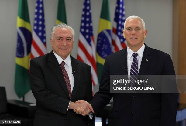 Brazilian President Michel Temer and US Vice-President Mike Pence laugh during a meeting at Planalto Palace in Brasilia on June 26, 2018. - Mike...