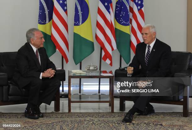 Brazilian President Michel Temer and US Vice-President Mike Pence talk during a meeting at Planalto Palace in Brasilia on June 26, 2018. - Mike Pence...