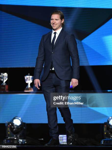 Nicklas Backstrom of the Washington Capitals walks onstage to present the NHL General Manager of the Year Award during the 2018 NHL Awards presented...