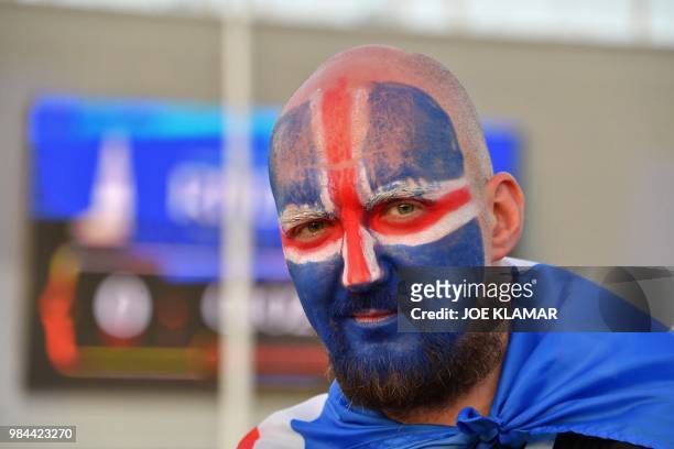 An Iceland's supporter poses ahead of the Russia 2018 World Cup Group D football match between Iceland and Croatia outstide the Rostov Arena in...