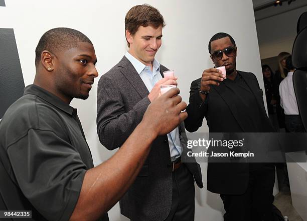 Football players LaDainian Tomlinson of the New York Jets and Eli Manning of the New York Giants and Sean Combs attend the launch of G Series Pro by...