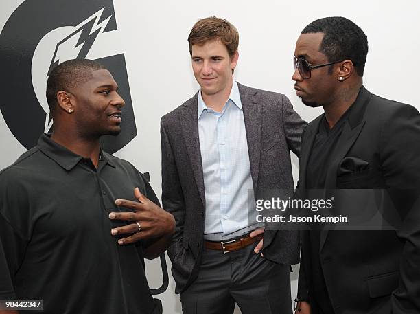 Football players LaDainian Tomlinson of the New York Jets and Eli Manning of the New York Giants and Sean Combs attend the launch of G Series Pro by...
