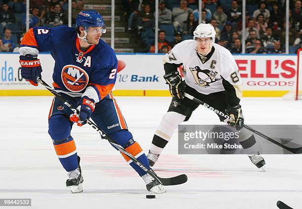 Sidney Crosby of the Pittsburgh Penguins skates against Mark Streit of the New York Islanders on April 11, 2010 at Nassau Coliseum in Uniondale, New...