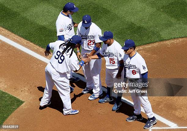 Manny Ramirez of the Los Angeles Dodgers is greeted by teammates Matt Kemp, Rafael Furcal and manager Joe Torre prior to the start of the game...