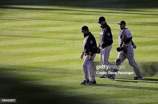 Pitching coach Dan Warthen, starting pitcher John Maine and catcher Rod Barajas of the New York Mets head from the bull pen to the dugout prior to...