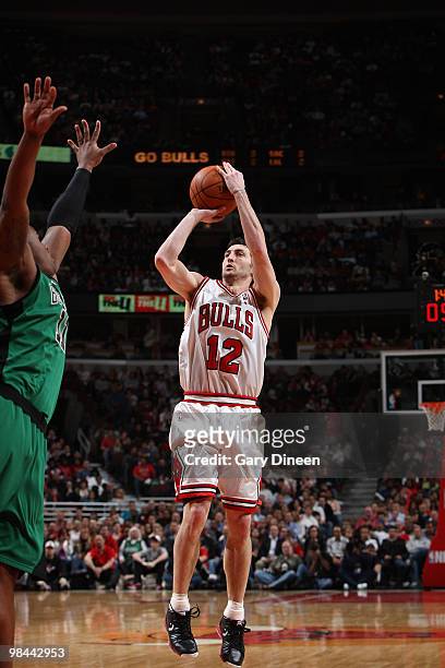 Kirk Hinrich of the Chicago Bulls shoots against Glen Davis of the Boston Celtics on April 13, 2010 at the United Center in Chicago, Illinois. NOTE...