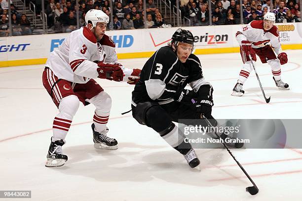 Jack Johnson of the Los Angeles Kings skates with the puck against Keith Yandle of the Phoenix Coyotes on April 8, 2010 at Staples Center in Los...