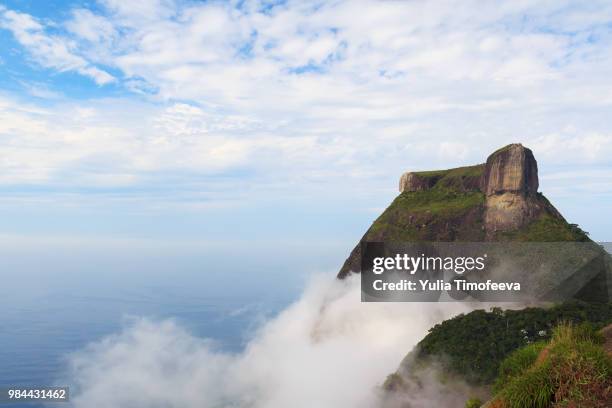 peak mountain pedra da gavea in clouds sky sea ocean, rio de jan - pedra stock pictures, royalty-free photos & images