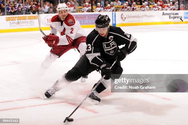 Dustin Brown of the Los Angeles Kings skates with the puck against James Vandermeer of the Phoenix Coyotes on April 8, 2010 at Staples Center in Los...