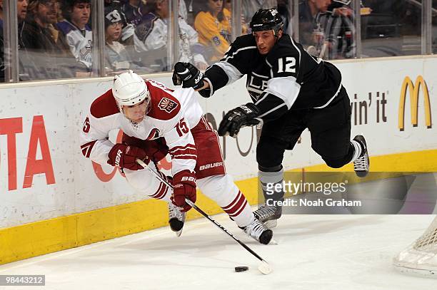 Matthew Lombardi of the Phoenix Coyotes is pushed while skating with the puck by Randy Jones of the Los Angeles Kings on April 8, 2010 at Staples...