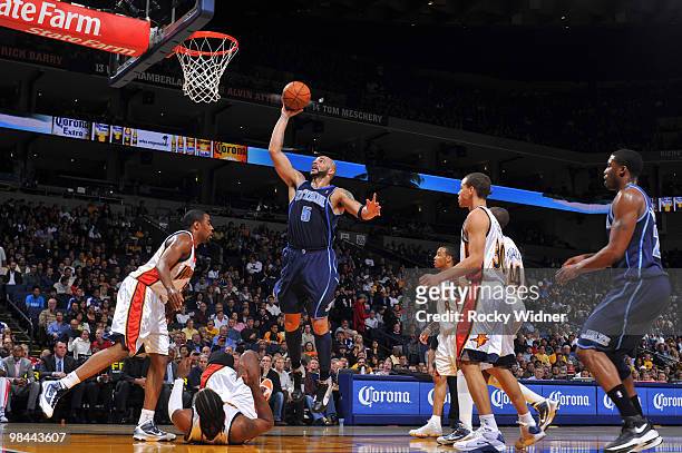 Carlos Boozer of the Utah Jazz scores inside against the Golden State Warriors on April 13, 2010 at Oracle Arena in Oakland, California. NOTE TO...