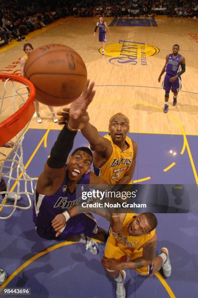Jason Thompson of the Sacramento Kings attempts a shot against Ron Artest and Shannon Brown of the Los Angeles Lakers at Staples Center on April 13,...