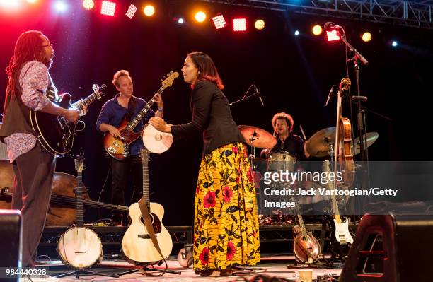 American folk and country singer and multi-instrumentalist Rhiannon Giddens performs on vocals and tambourine with her band with, from left,...